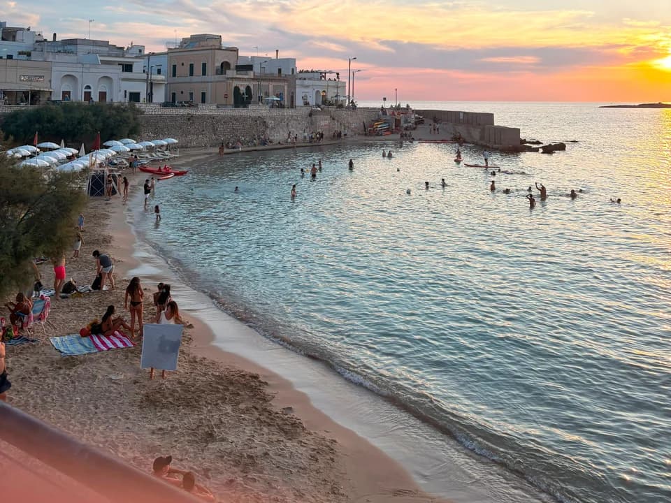 A coastal town and beach at sunset